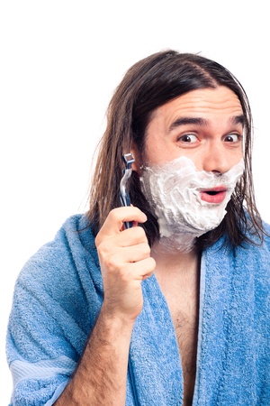 Happy funny longhaired man going to shave after bath, isolated on white background.の写真素材