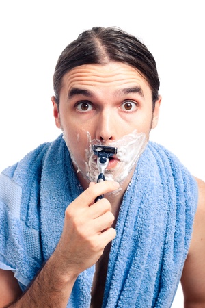 Young shocked man shaving after bath, isolated on white background.の写真素材