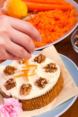 Close up of decorating carrot cake with fresh carrots.の写真素材