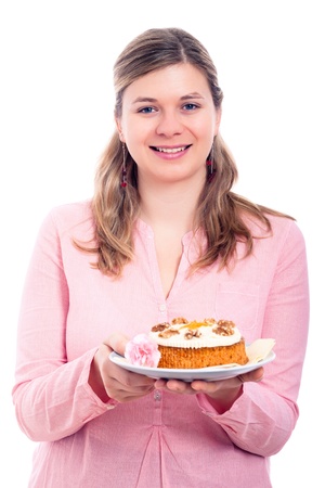 Happy woman in pink holding plate with homemade delicious carrot cake, isolated on white background.の写真素材