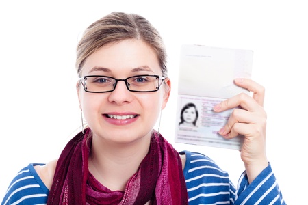 Happy tourist traveller woman showing passport, isolated on white background.の写真素材