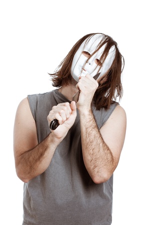 Scary bizarre masked man holding knife, isolated on white background.の写真素材