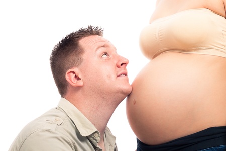 Happy expectant father and detail of pregnant woman, isolated on white background.の写真素材