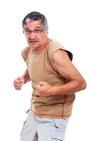 Confident sporty senior man posing, isolated on white background.の写真素材