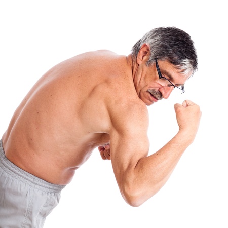 Senior man posing and showing his biceps, isolated on white background.の写真素材