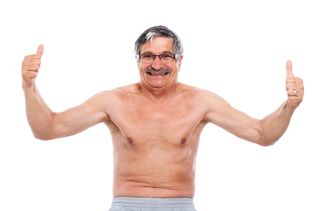 Happy smiling naked senior man showing his body, isolated on white background.の写真素材