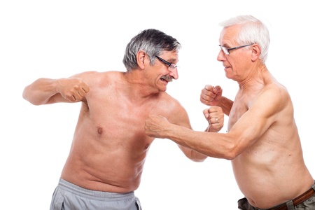 Two naked senior men fighting, isolated on white background.の写真素材