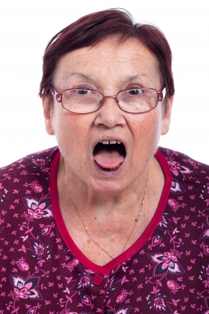 Shocked elderly woman, isolated on white background.の写真素材