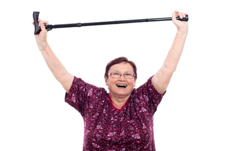 Happy laughing elderly woman holding walking stick, isolated on white background.の写真素材