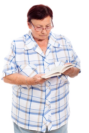 Elderly woman reading book, isolated on white background.の写真素材