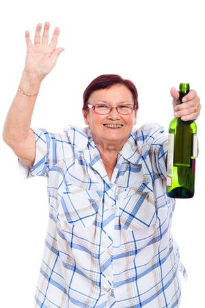 Elderly happy drunk woman with bottle of alcohol, isolated on white background.の写真素材