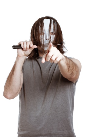 Scary masked killer with knife, pointing at you, isolated on white background.の写真素材