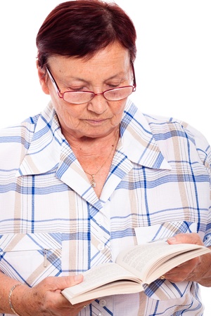 Close up of senior woman reading book, isolated on white background.の写真素材