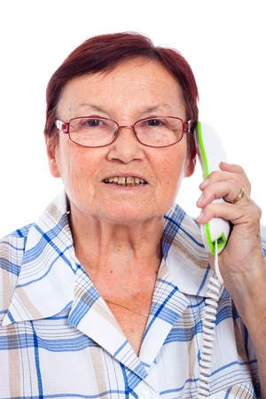 Close up of happy senior woman on the phone, isolated on white background.の写真素材