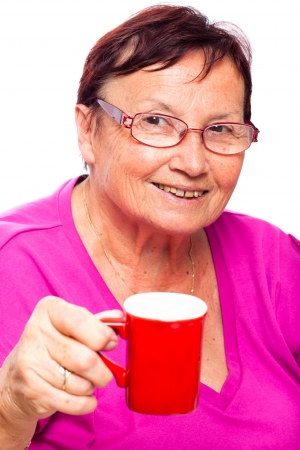 Happy smiling senior woman holding cup of coffee, isolated on white background.の写真素材