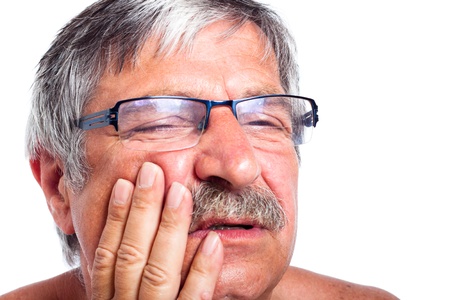 Close up of senior man face with toothache, isolated on white background.の写真素材