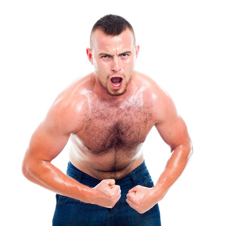 Angry young muscular sports man, isolated on white background.の写真素材