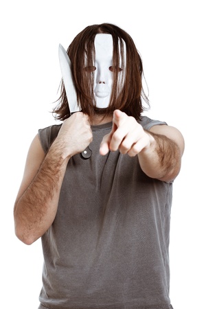 Bizarre masked man with knife, pointing at you, isolated on white background.の写真素材