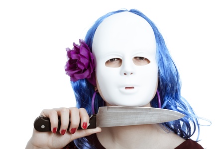 Scary bizarre masked woman with knife, isolated on white background.の写真素材