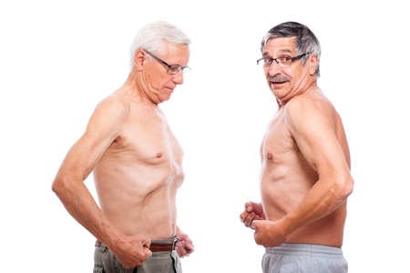 Two seniors comparing figure, isolated on white background.の写真素材