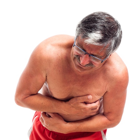 Senior man with painful stomach ache, isolated on white background.の写真素材