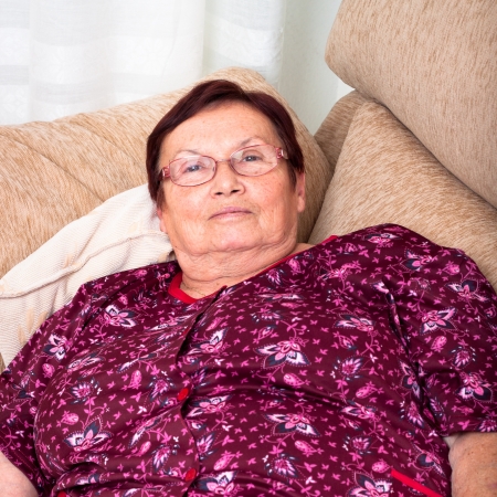 Close up of elderly woman relaxing on sofa.の写真素材