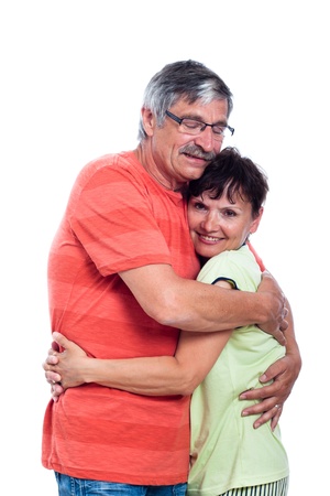 Portrait of happy middle aged couple hugging, isolated on white background.の写真素材