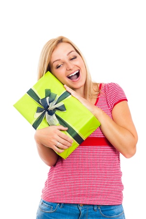 Young attractive blond happy woman holding green gift box, isolated on white background.の写真素材
