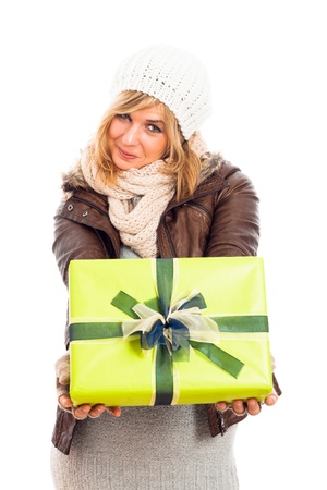 Young happy smiling woman holding green gift box, isolated on white background.の写真素材