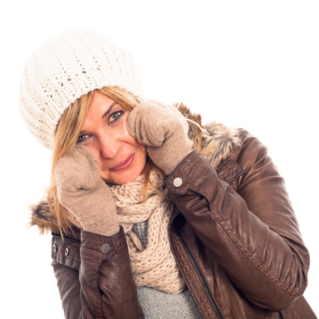 Young happy woman in winter clothes, isolated on white background.の写真素材