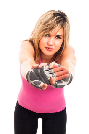 Young happy sporty fitness woman stretching, isolated on white background.の写真素材