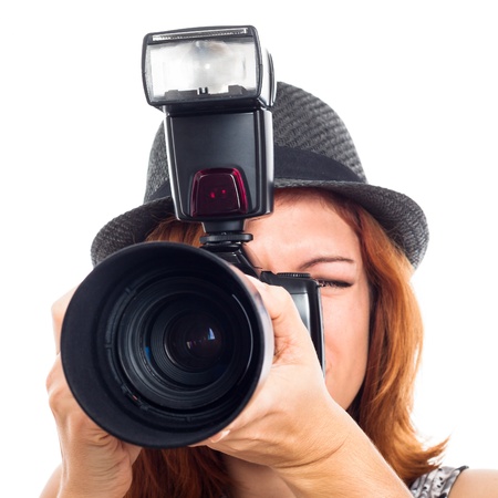 Close up of female photojournalist holding camera, isolated on white background.の写真素材