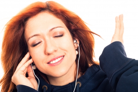 Close up of young woman enjoying listening music, isolated on white background.の写真素材