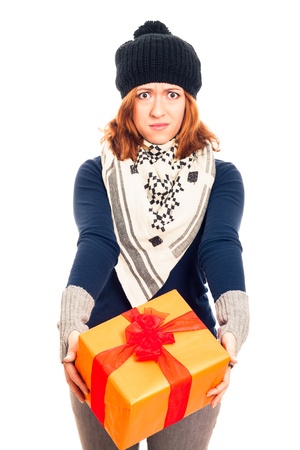 Angry disappointed woman holding gift box, isolated on white background.の写真素材