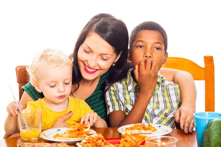Young happy smiling woman with children eating pizza, isolated on white background.の写真素材