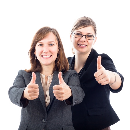 Two young happy business women gesturing thumbs up, isolated on white background.の写真素材