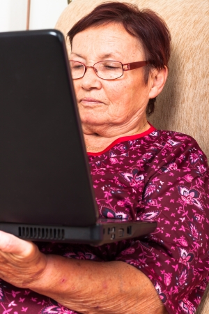 Close up of senior woman using laptop.の写真素材