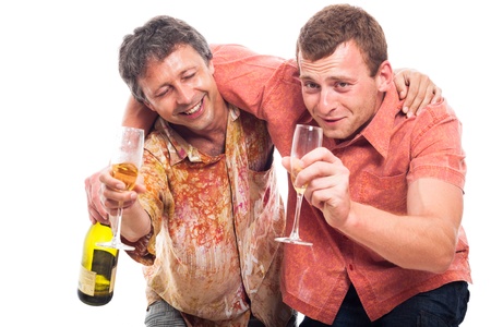 Two funny drunken men holding bottle and glass of alcohol, isolated on white background.の写真素材