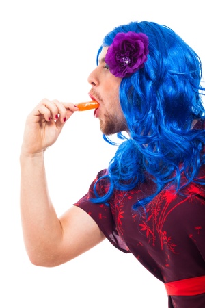 Cross dressing man eating ice pop, isolated on white background.の写真素材