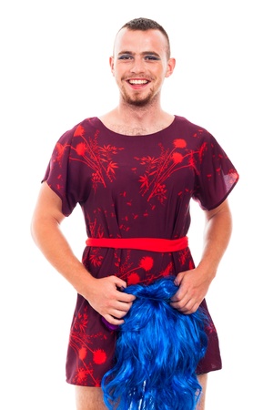 Portrait of happy laughing transvestite holding blue wig, isolated on white background.の写真素材