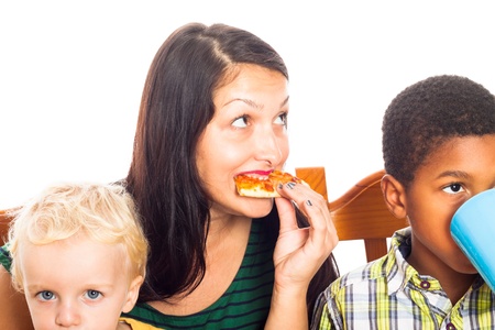 Detail of young woman with children eating pizza, isolated on white background.の写真素材