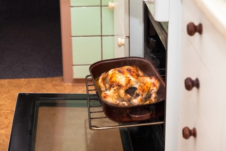 Detail of kitchen and baking chicken in oven.の写真素材