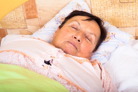 Close up of senior woman sleeping in bed.の写真素材