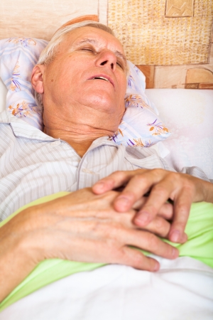 Close up of senior man sleeping in bed.の写真素材