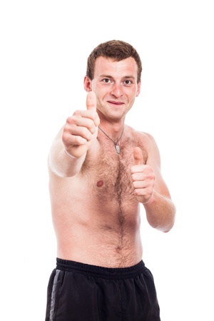 Young shirtless man showing thumbs up, isolated on white backgroundの写真素材