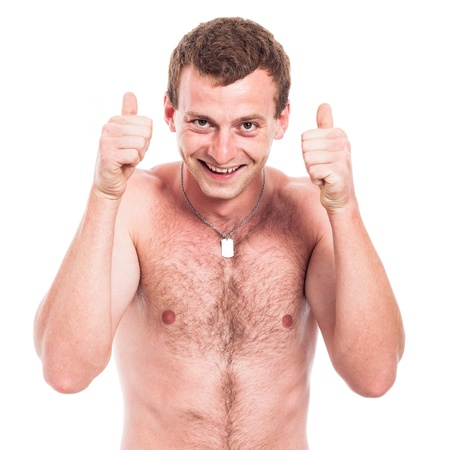 Young ecstatic shirtless man showing thumbs up, isolated on white backgroundの写真素材
