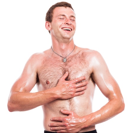 Ecstatic shirtless man touching his body, isolated on white backgroundの写真素材
