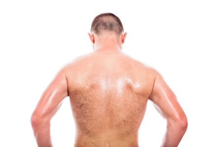 Rear view of young shirtless man, isolated on white background