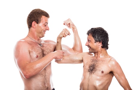 Funny shirtless men comparing muscles, isolated on white backgroundの写真素材
