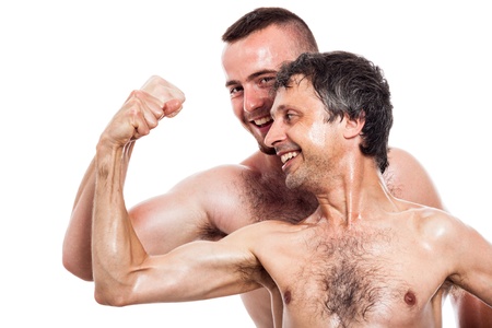 Funny shirtless men comparing biceps, isolated on white backgroundの写真素材